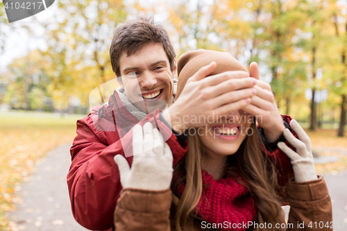 Image of happy young couple having fun in autumn park