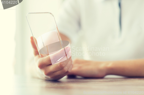 Image of close up of woman with transparent smartphone