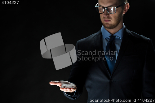 Image of close up of businessman holding something on hand