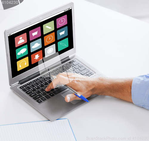 Image of businessman with laptop computer working at office