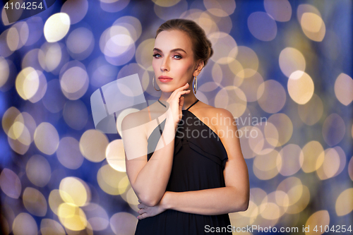 Image of beautiful woman in black wearing diamond jewelry