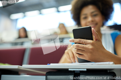 Image of close up of african student with smartphone