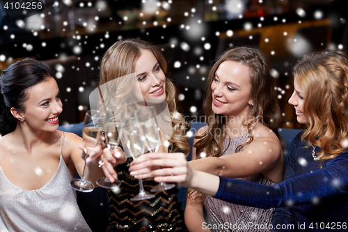 Image of happy women with champagne glasses at night club