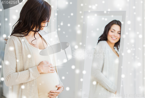 Image of close up of pregnant woman looking to mirror
