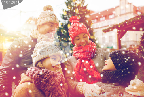 Image of happy family over city christmas tree and snow
