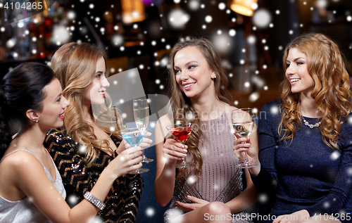 Image of happy women with drinks at night club