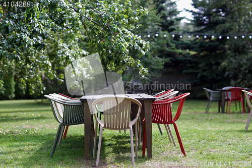 Image of table with chairs at summer garden