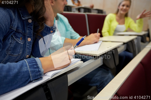 Image of group of students with notebooks at lecture hall