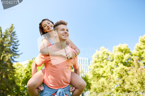 Image of happy teenage couple having fun at summer park