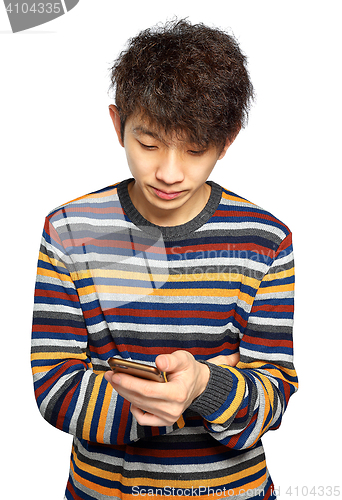 Image of Young man using mobile phone texting