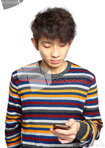 Image of Young man using mobile phone texting