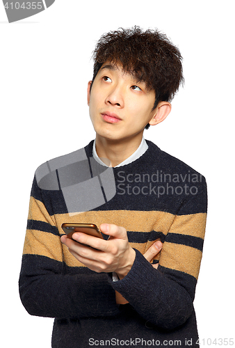 Image of young asia man texting on mobilephone