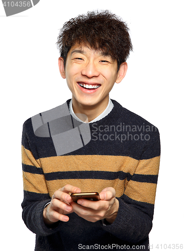 Image of Young man using mobile phone texting