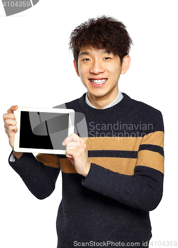 Image of Handsome young Asian man using tablet / pad