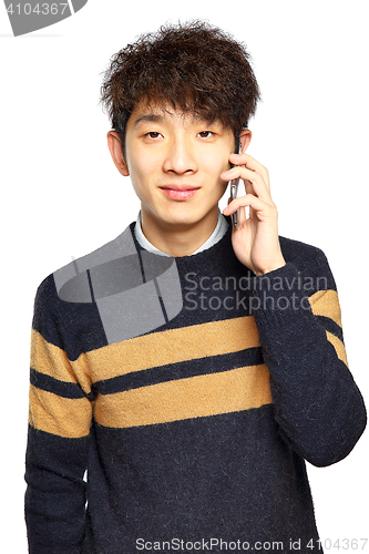 Image of Happy young man talking on mobilephone