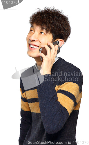 Image of Happy young man talking on mobilephone