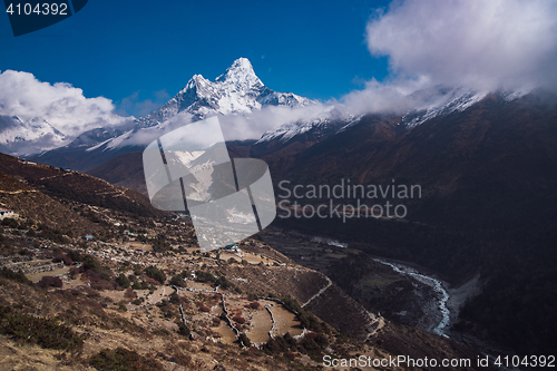 Image of Ama Dablam summit or peak and Nepalese village in Himalayas