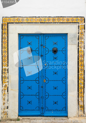 Image of Blue aged door with ornament and tiles from Sidi Bou Said 