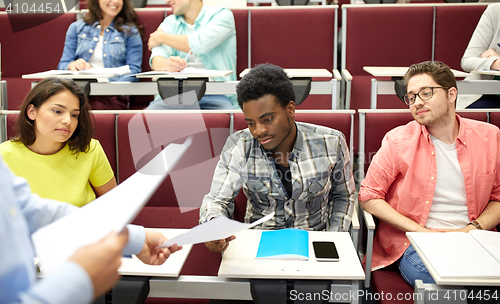 Image of teacher giving tests to students at lecture