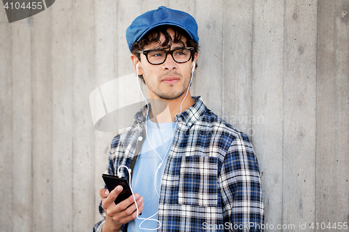 Image of man with earphones and smartphone listening music