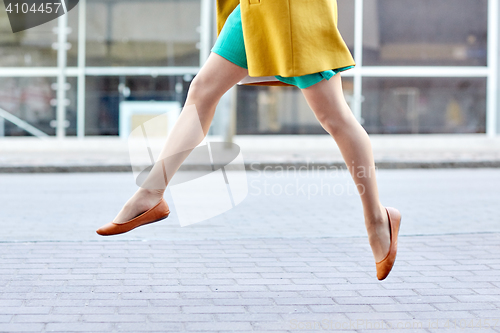 Image of young woman or teenage girl legs on city street