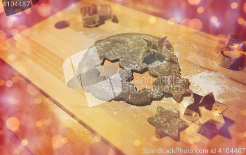 Image of christmas gingerbread dough and molds on board