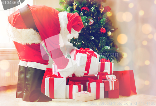 Image of man in costume of santa claus with presents