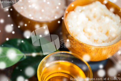 Image of close up of body scrub in wooden bowl and honey