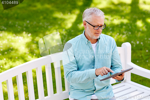 Image of senior man with tablet pc at summer park