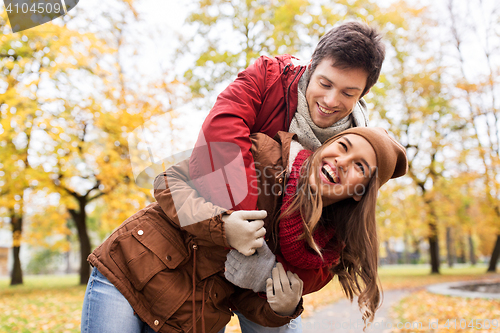 Image of happy young couple hugging in autumn park