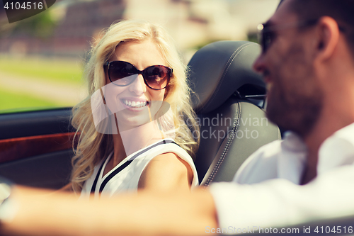 Image of happy man and woman driving in cabriolet car