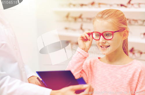 Image of optician and girl choosing glasses at optics store