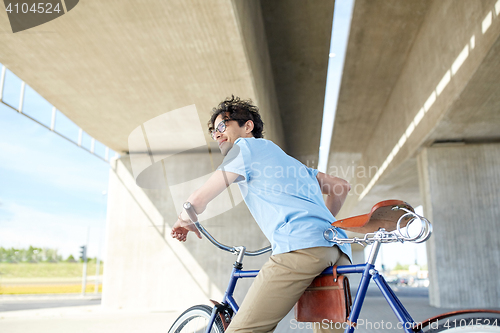 Image of young hipster man riding fixed gear bike