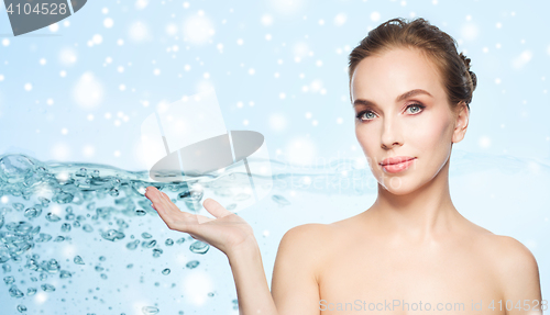 Image of smiling young woman over water and snow