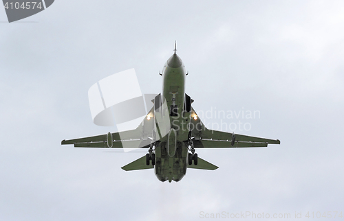 Image of Military jet bomber Su-24 Fencer flying above the clouds.