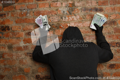 Image of Burglar with money in hand