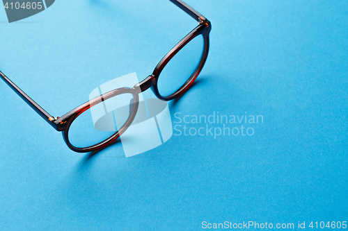 Image of Brown spectacles on blue background
