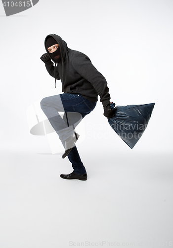 Image of Thief slinking in black mask