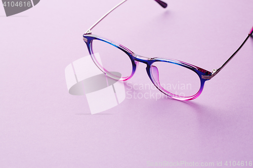 Image of Eyeglasses in empty purple background