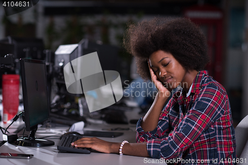 Image of a young African American woman feels tired in the modern office