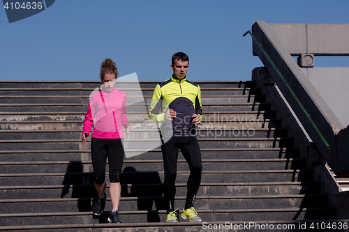 Image of young  couple jogging on steps