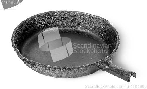 Image of Empty old cast iron frying pan rotated