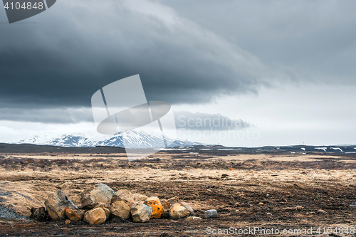 Image of Rocks on a field with mountains