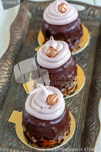 Image of Cupcakes with chocolate frosting and walnuts.