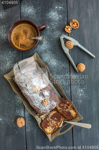 Image of Homemade chocolate cake, cup of coffee and walnuts.