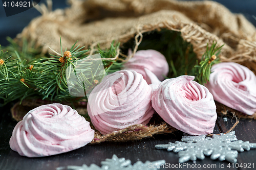 Image of Homemade marshmallows berries and spruce branches.