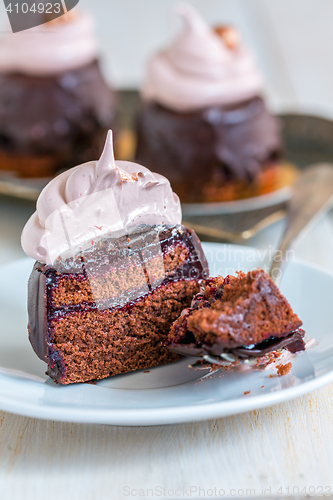 Image of Slice of chocolate cupcakes with berry confit and Swiss meringue