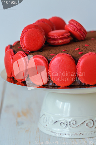 Image of Chocolate cake decorated with macarons closeup.