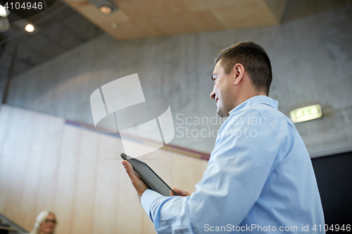 Image of teacher with tablet pc at lecture hall