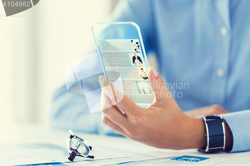 Image of close up of woman with transparent smartphone